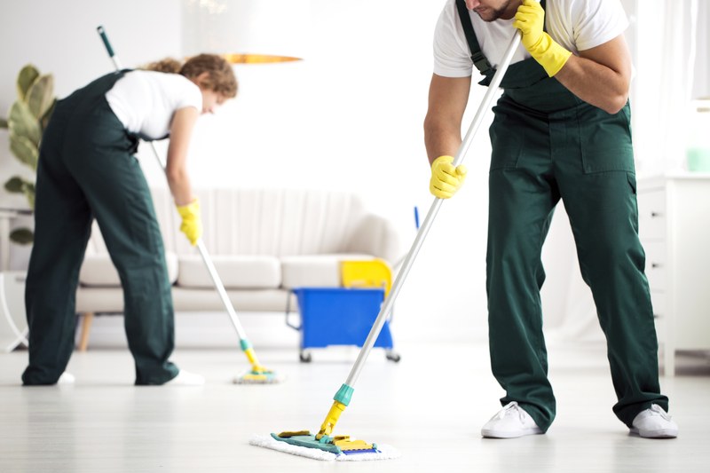 Two cleaners working a floor together with microfibre flat mops